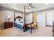 Main bedroom boasts tray ceilings, a four-poster bed, and an en-suite bathroom for added convenience at 16101 Iola St, Brighton, CO 80602