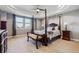 Elegant main bedroom featuring a four-poster bed, tray ceiling, and large windows for natural light at 16101 Iola St, Brighton, CO 80602