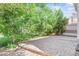 Spacious brick patio surrounded by lush greenery and mature trees at 15021 Josephine St, Thornton, CO 80602
