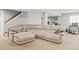 A finished basement featuring a large couch and an adjacent stairwell at 15021 Josephine St, Thornton, CO 80602