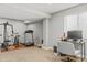 Finished basement features workout space with modern exercise equipment and a desk at 15021 Josephine St, Thornton, CO 80602