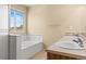 This primary bathroom features a soaking tub, double sinks, and good natural lighting at 15021 Josephine St, Thornton, CO 80602