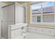 A bathtub, shower, and exterior window in this bright bathroom at 15021 Josephine St, Thornton, CO 80602