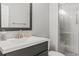 Modern bathroom with sleek vanity, brushed gold fixtures, and glass enclosed shower at 15021 Josephine St, Thornton, CO 80602