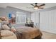 Bright bedroom with natural light, spacious closet, and ceiling fan at 15021 Josephine St, Thornton, CO 80602