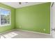 An empty bedroom featuring an interesting green paint color at 15021 Josephine St, Thornton, CO 80602