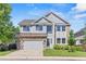 Charming two-story home with a two car garage and stone and siding exterior at 15021 Josephine St, Thornton, CO 80602