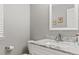 Half bathroom with marble counter top, grey walls and a white framed mirror at 15021 Josephine St, Thornton, CO 80602