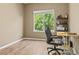Home office with hardwood floors, natural light and a modern black desk chair at 15021 Josephine St, Thornton, CO 80602