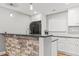 Beautiful kitchen with stone accent bar, stainless appliances, and white subway tile backsplash at 15021 Josephine St, Thornton, CO 80602