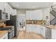 Kitchen features stainless steel appliances, and white cabinets at 15021 Josephine St, Thornton, CO 80602