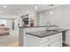 Modern kitchen with stainless appliances, granite counters, and decorative shelving at 15021 Josephine St, Thornton, CO 80602