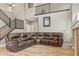 Open floor plan with hardwood floors, gray walls, and a sectional sofa at 15021 Josephine St, Thornton, CO 80602