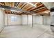 The unfinished basement offers a clean slate for customization with exposed ceiling and concrete flooring at 4742 Raven Run, Broomfield, CO 80023