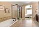 Well-lit primary bathroom featuring a tub, shower, and access to the bedroom at 4742 Raven Run, Broomfield, CO 80023