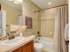 A charming bathroom features a shower over tub, tiled floors, and a vanity with storage and decor at 4742 Raven Run, Broomfield, CO 80023