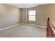 Neutral paint and carpet create a clean slate in this bonus bedroom on the upper level at 4742 Raven Run, Broomfield, CO 80023