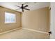 Empty bedroom with ceiling fan and window at 4742 Raven Run, Broomfield, CO 80023