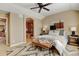 Neutral bedroom featuring a decorative rug, bench, and art hanging above the bed at 4742 Raven Run, Broomfield, CO 80023