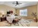 Cozy bedroom with large window, ceiling fan, decorative accents, and neutral color palette at 4742 Raven Run, Broomfield, CO 80023