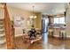Open floor plan showcasing dining area, kitchen with breakfast bar and wood floors at 4742 Raven Run, Broomfield, CO 80023