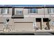 Two-story townhome exterior features a two-car garage, muted siding, and well-maintained landscaping at 4742 Raven Run, Broomfield, CO 80023