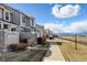Townhome exteriors with stone and muted siding, and views of snow capped mountains in the distance at 4742 Raven Run, Broomfield, CO 80023