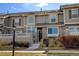 Charming townhome features stone accents, a well-maintained lawn, and a welcoming entrance at 4742 Raven Run, Broomfield, CO 80023