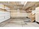 Spacious two car garage with painted walls, storage racks, and stairs to interior of property at 4742 Raven Run, Broomfield, CO 80023