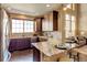 Modern kitchen with granite countertops, stainless appliances, and breakfast bar seating at 4742 Raven Run, Broomfield, CO 80023