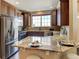 Modern kitchen with stainless steel appliances, granite counters, and dark wood cabinets at 4742 Raven Run, Broomfield, CO 80023