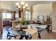 Open concept living room and kitchen features dining table and vaulted ceilings at 4742 Raven Run, Broomfield, CO 80023