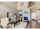 Inviting living room with fireplace, high ceilings, and hardwood floors at 4742 Raven Run, Broomfield, CO 80023