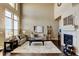 Bright living room with fireplace, hardwood floors, and tall ceilings at 4742 Raven Run, Broomfield, CO 80023