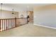 This is a lofted bonus space with neutral walls and carpet, with views to the downstairs at 4742 Raven Run, Broomfield, CO 80023
