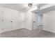 Bedroom featuring plush carpet, white walls, and a door to another room at 11820 Lincoln St, Northglenn, CO 80233