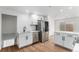 Updated kitchen featuring stainless steel appliances, white cabinets, and quartz countertops at 11820 Lincoln St, Northglenn, CO 80233