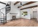 Bright living room features vaulted ceilings, exposed beams, a cozy fireplace, and a unique spiral staircase at 11820 Lincoln St, Northglenn, CO 80233