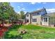Expansive backyard featuring a deck, gazebo, lush lawn, and well-maintained landscaping, perfect for outdoor living at 9994 Quintero St, Commerce City, CO 80022