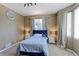 Comfortable bedroom with soft carpet, natural light, and neutral decor at 9994 Quintero St, Commerce City, CO 80022