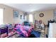 Relaxing bedroom with blue area rug, a black leather chair and eclectic decorations at 9994 Quintero St, Commerce City, CO 80022