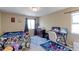Spacious bedroom with a large window, neutral walls, and carpeted floors at 9994 Quintero St, Commerce City, CO 80022