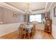 Charming dining room with a chandelier, large window, and a table set for six, creating an inviting atmosphere at 9994 Quintero St, Commerce City, CO 80022