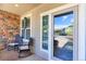 Inviting front porch features seating, brick accents, and decor for a cozy outdoor space at 9994 Quintero St, Commerce City, CO 80022