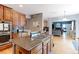 Well-equipped kitchen with wood cabinets, center island, granite countertops and hardwood floors at 9994 Quintero St, Commerce City, CO 80022
