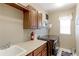 Functional laundry room with washer, dryer, sink, cabinets, and counter space at 9994 Quintero St, Commerce City, CO 80022