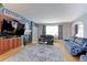 Open living room with hardwood floors, fireplace, and a comfortable seating area at 9994 Quintero St, Commerce City, CO 80022