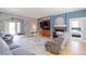 Open living room with hardwood floors, fireplace, and access to other rooms at 9994 Quintero St, Commerce City, CO 80022