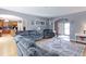 Bright living room featuring hardwood floors, arched doorways, and stylish furniture at 9994 Quintero St, Commerce City, CO 80022