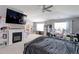 Spacious main bedroom with a fireplace, ceiling fan, and natural light from the windows at 9994 Quintero St, Commerce City, CO 80022